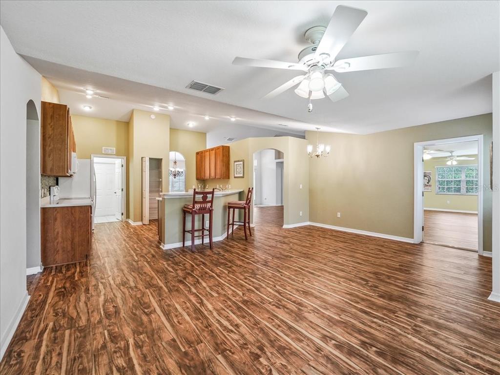 11025 Southeast 174th Loop Summerfield, FL 34491 - Photo 22 of 52 a view of a kitchen with kitchen island stainless steel appliances wooden floor and a view of living room