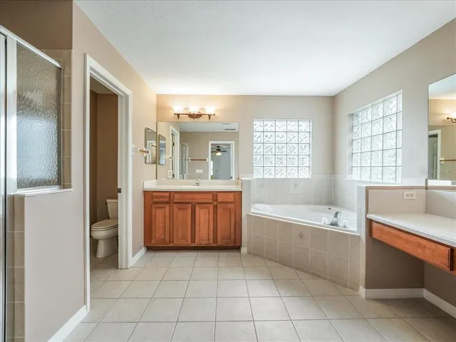 a bathroom with a tub sink and a mirror