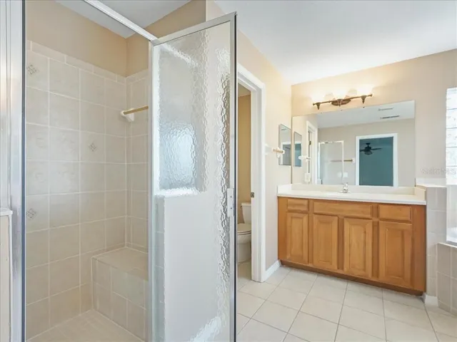 a spacious bathroom with a mirror sink and shower
