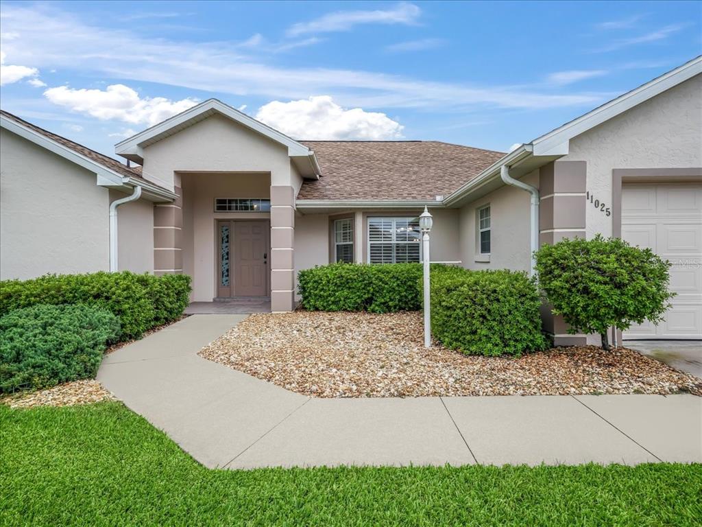 11025 Southeast 174th Loop Summerfield, FL 34491 - Photo 3 of 52 a front view of a house with garden
