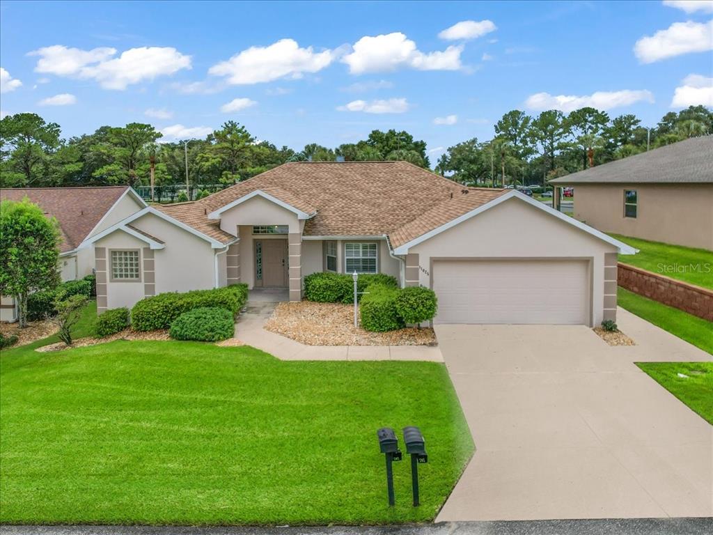 11025 Southeast 174th Loop Summerfield, FL 34491 - Photo 44 of 52 a front view of a house with a yard