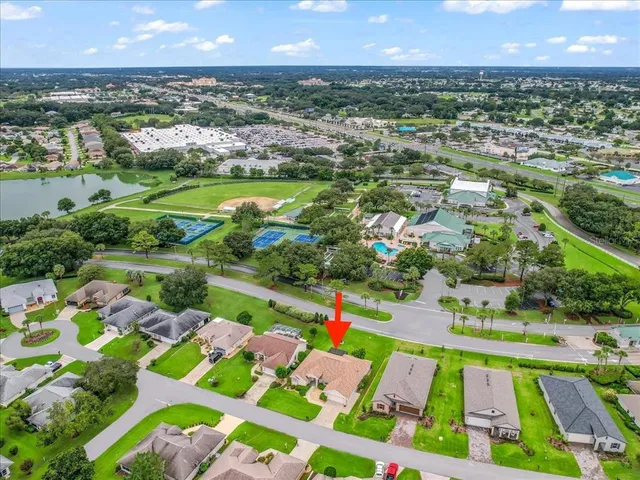 an aerial view of residential house with outdoor space and parking