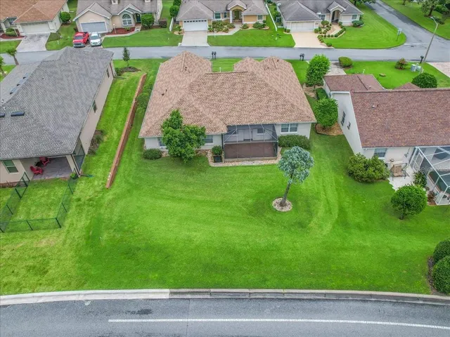 a view of a house with a backyard