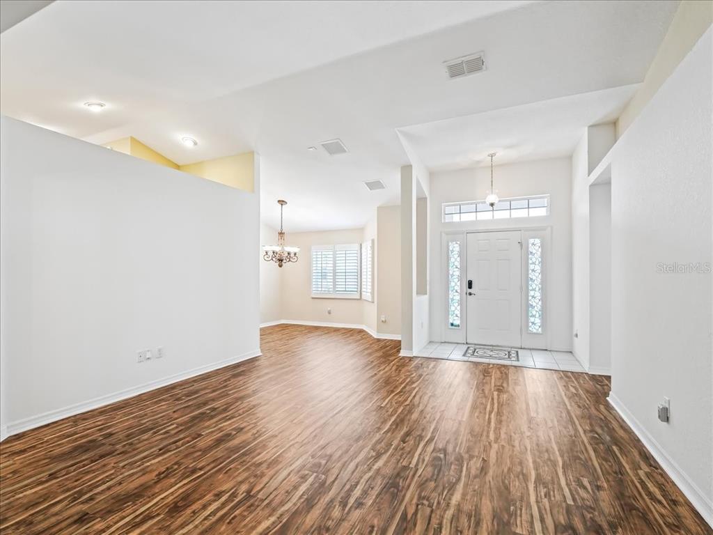 11025 Southeast 174th Loop Summerfield, FL 34491 - Photo 5 of 52 a view of an empty room with wooden floor
