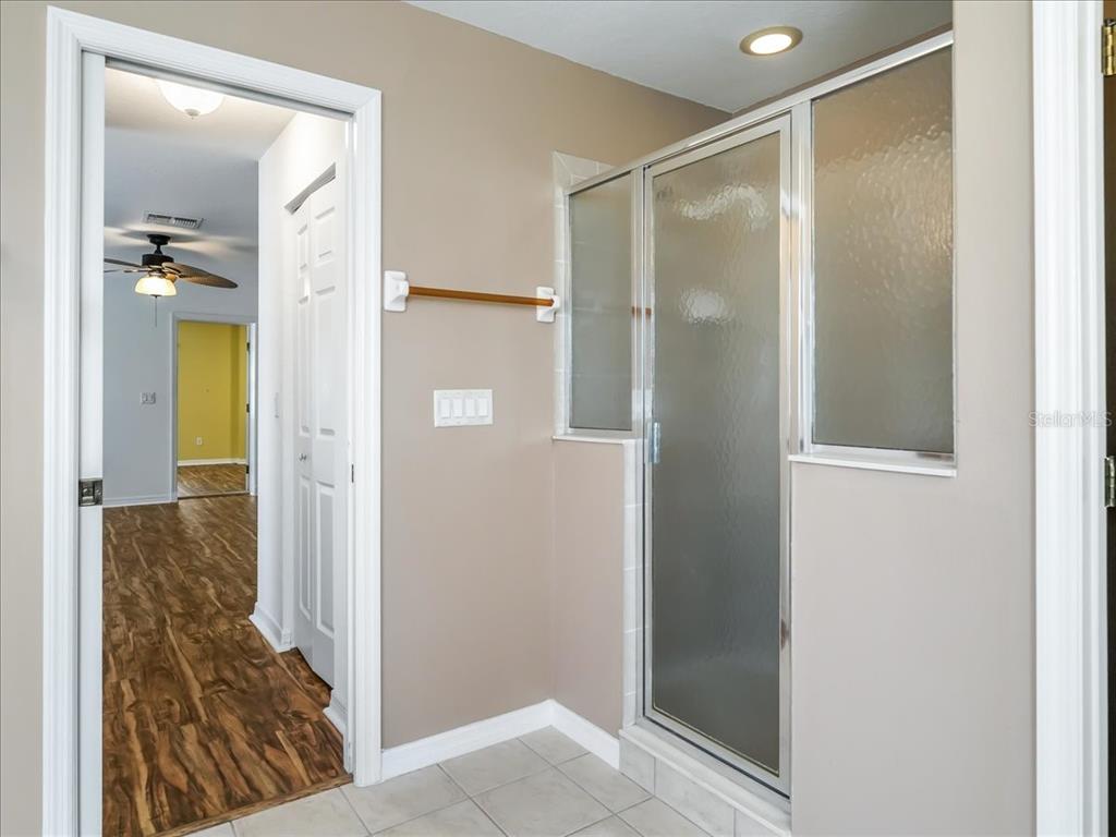 11025 Southeast 174th Loop Summerfield, FL 34491 - Photo 52 of 52 a bathroom with a glass shower door and a sink