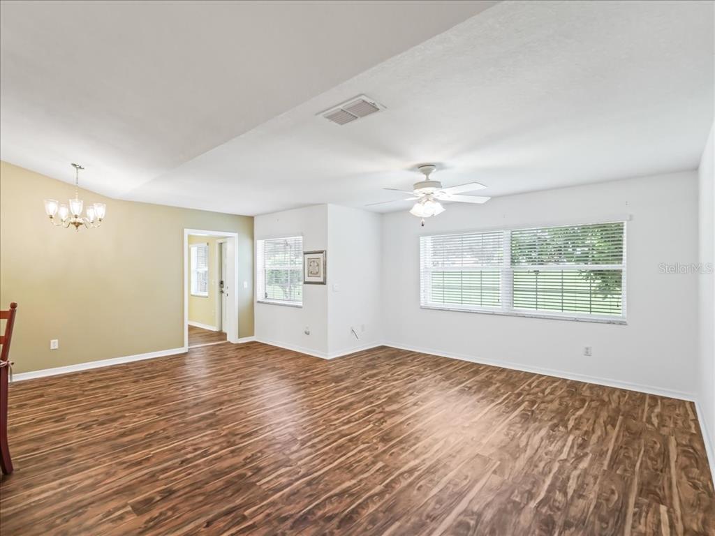 11025 Southeast 174th Loop Summerfield, FL 34491 - Photo 9 of 52 a view of an empty room with wooden floor and a window