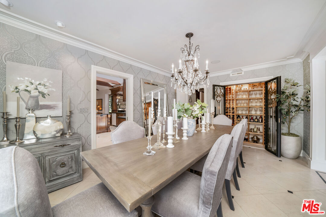 16632 Bienveneda Place Pacific Palisades, CA 90272 - Photo 14 of 62 a view of a dining room with furniture and chandelier