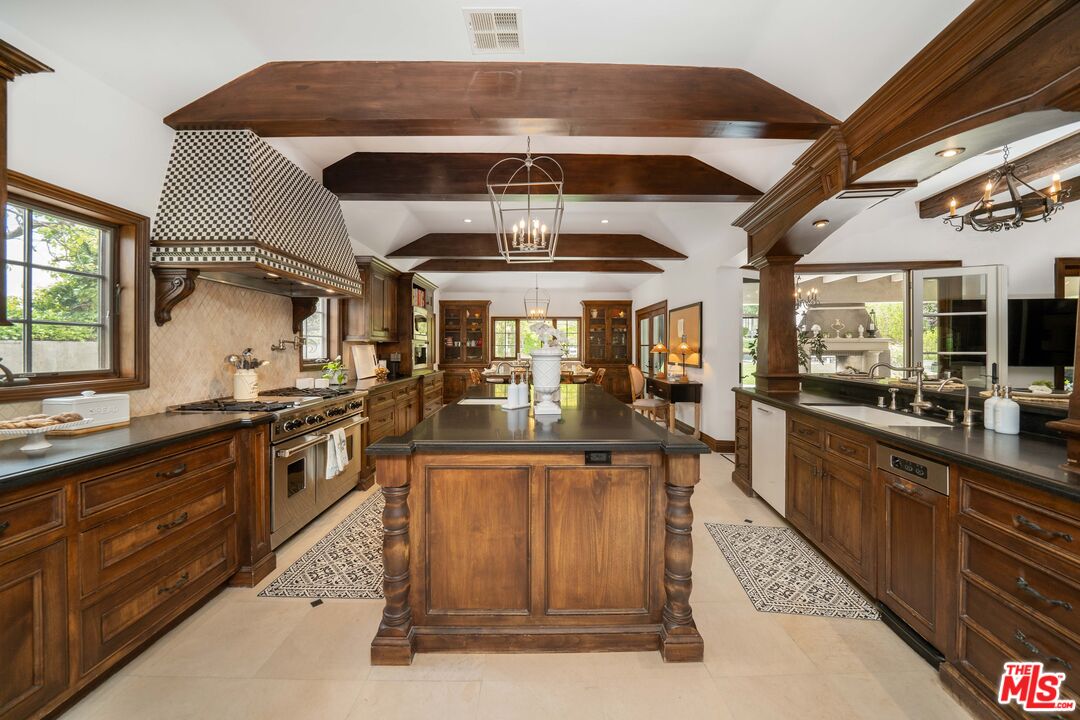 16632 Bienveneda Place Pacific Palisades, CA 90272 - Photo 17 of 62 a kitchen with stainless steel appliances granite countertop a stove and a sink