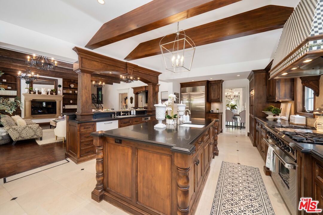 16632 Bienveneda Place Pacific Palisades, CA 90272 - Photo 18 of 62 a kitchen with stainless steel appliances granite countertop a sink and cabinets