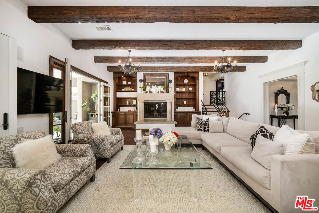16632 Bienveneda Place Pacific Palisades, CA 90272 - Photo 23 of 62 a living room with furniture and a flat screen tv