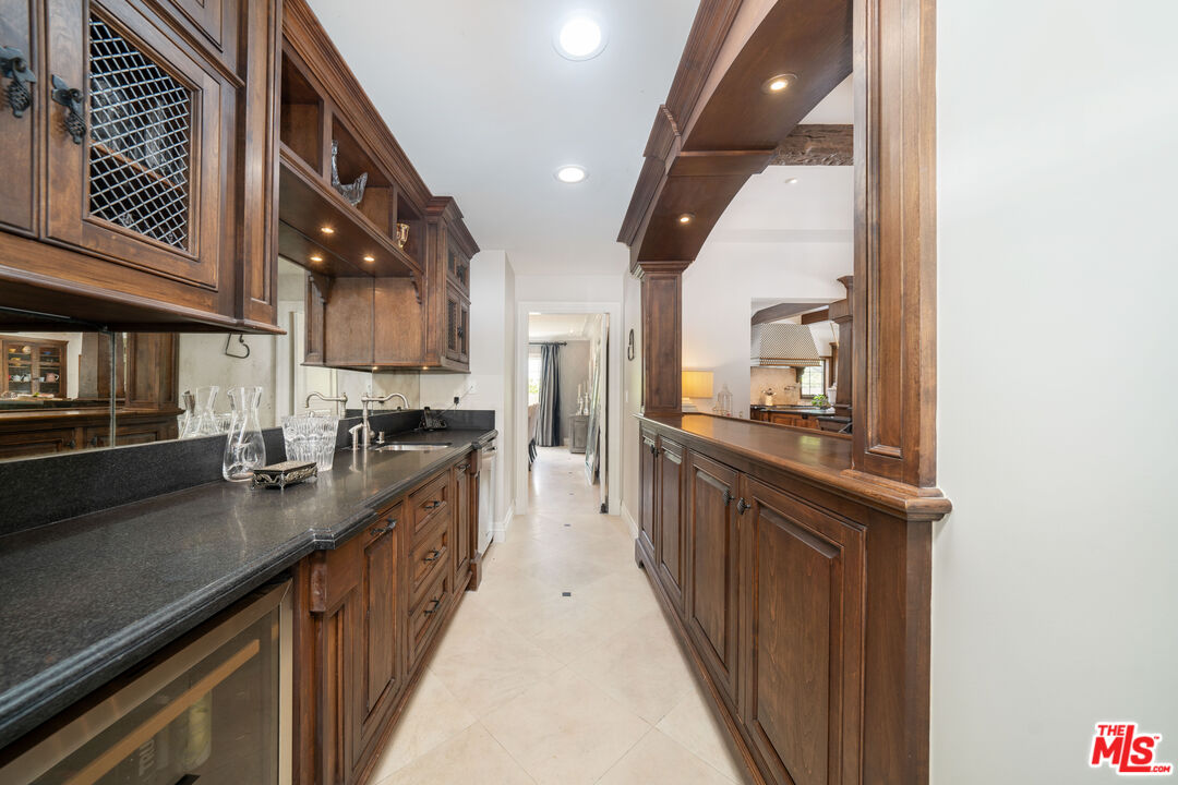 16632 Bienveneda Place Pacific Palisades, CA 90272 - Photo 26 of 62 a kitchen with stainless steel appliances granite countertop a sink and stove