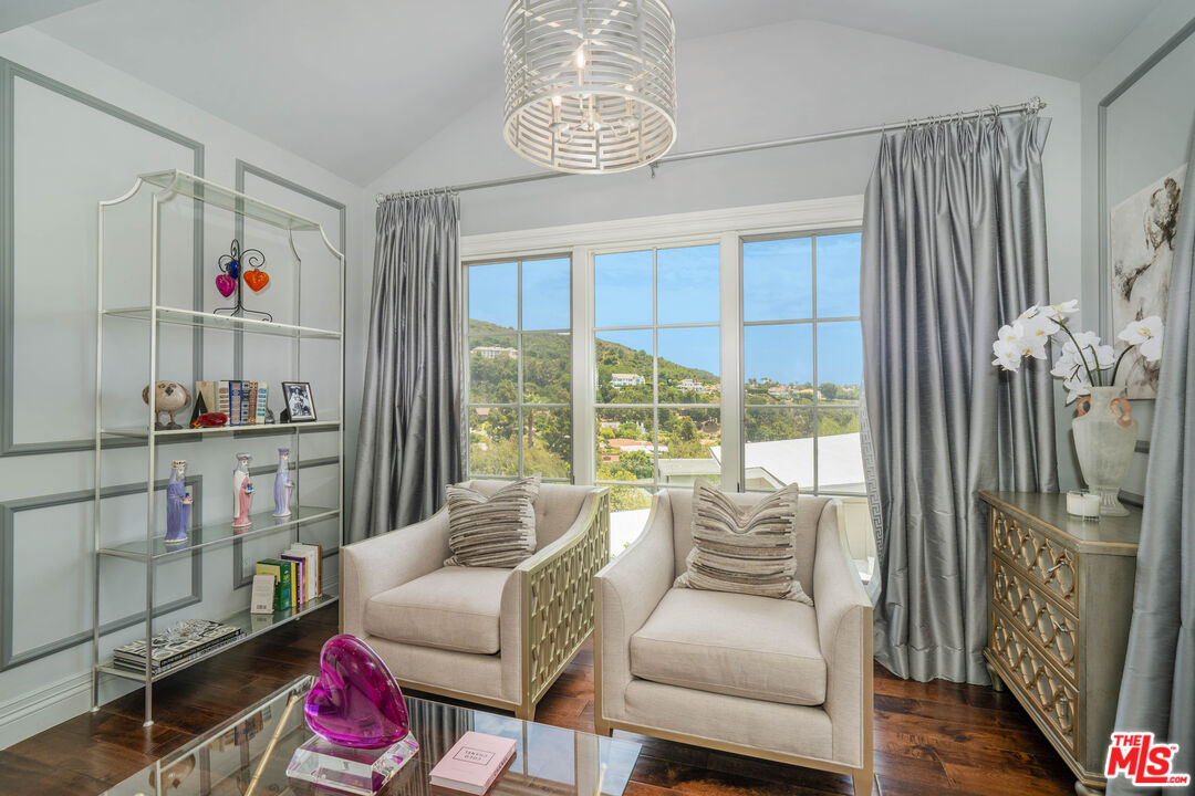 16632 Bienveneda Place Pacific Palisades, CA 90272 - Photo 28 of 62 a living room with furniture and a floor to ceiling window