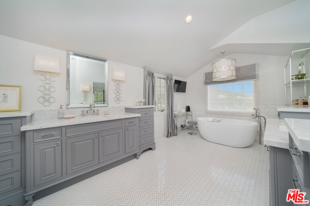 16632 Bienveneda Place Pacific Palisades, CA 90272 - Photo 29 of 62 a bathroom with a granite countertop sink and a mirror