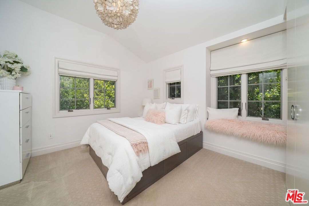 16632 Bienveneda Place Pacific Palisades, CA 90272 - Photo 32 of 62 a bedroom with a large bed and a window