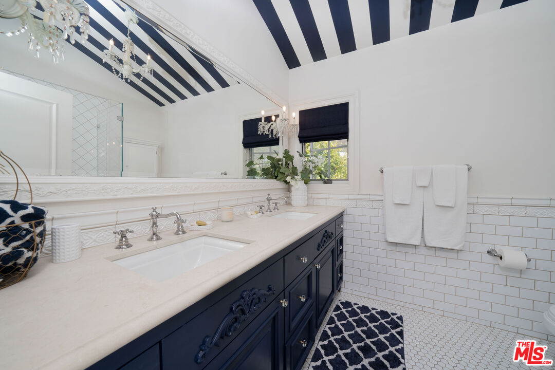 16632 Bienveneda Place Pacific Palisades, CA 90272 - Photo 34 of 62 a bathroom with a double vanity sink and a mirror