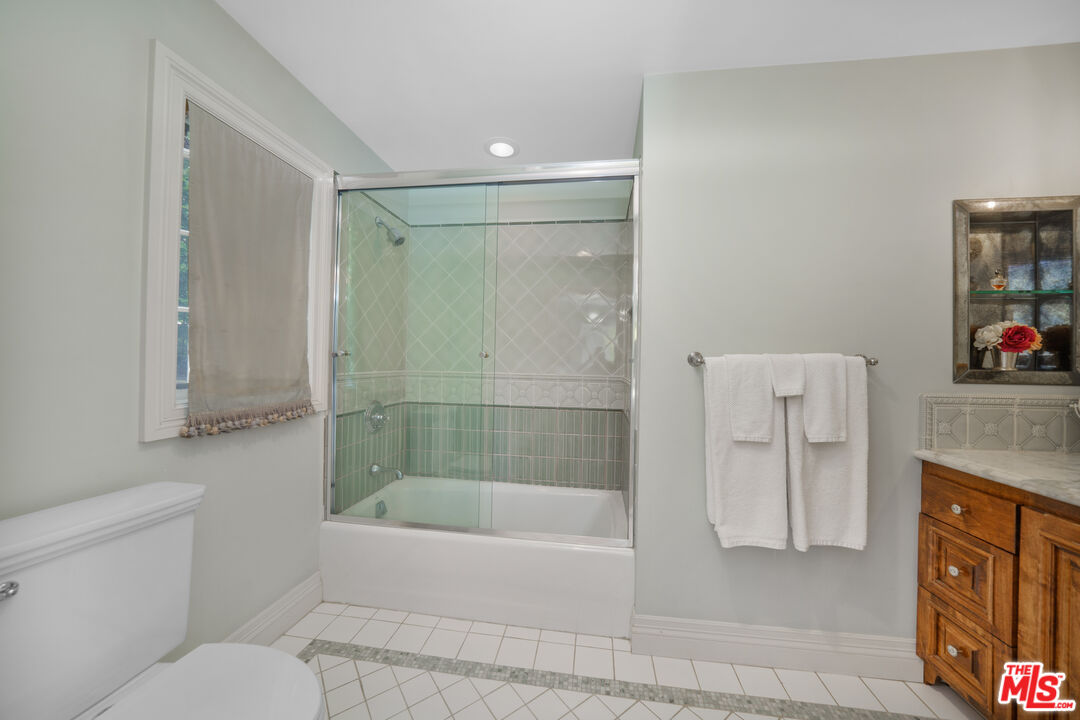 16632 Bienveneda Place Pacific Palisades, CA 90272 - Photo 41 of 62 a bathroom with a tub shower and toilet