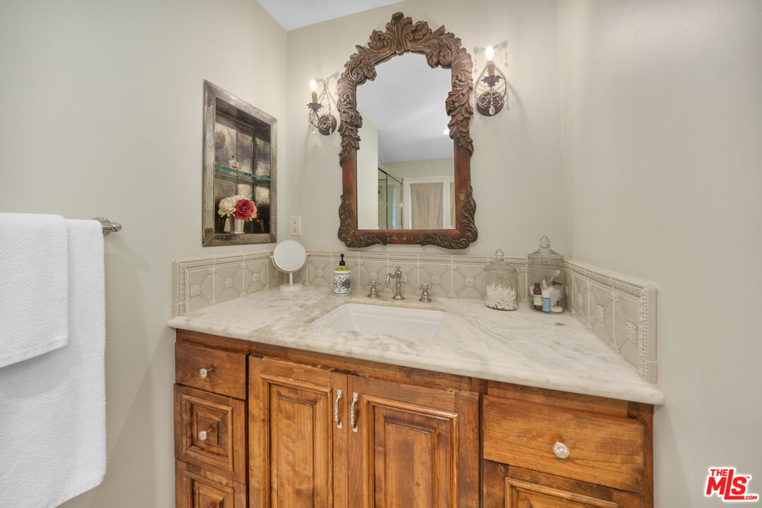 16632 Bienveneda Place Pacific Palisades, CA 90272 - Photo 45 of 62 a bathroom with a sink and a mirror