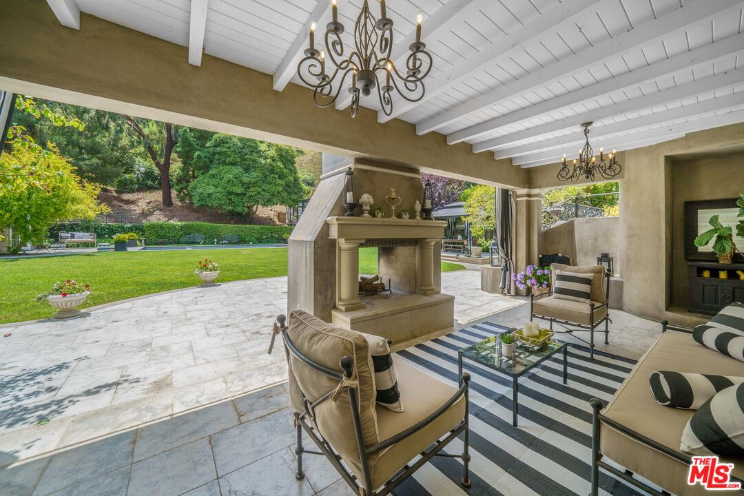 16632 Bienveneda Place Pacific Palisades, CA 90272 - Photo 46 of 62 a living room with patio furniture and a yard