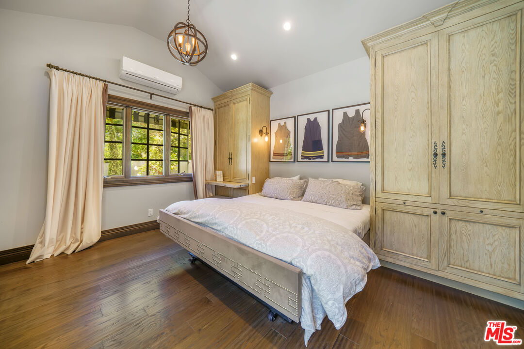 16632 Bienveneda Place Pacific Palisades, CA 90272 - Photo 54 of 62 a spacious bedroom with a bed and a window