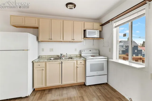 a kitchen with a sink a stove and cabinets
