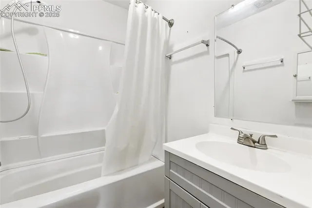 a bathroom with a bathtub and a window