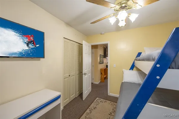 a view of a bedroom with wooden floor and staircase
