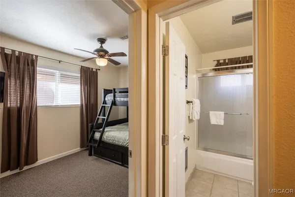 a view of a hallway with closet and a livingroom with furniture