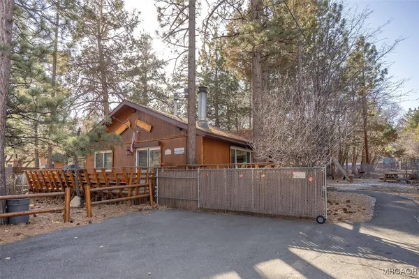 a view of a house with a yard and wooden fence