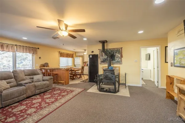 a living room with furniture ceiling fan and a rug