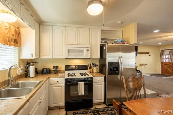 a kitchen that has a sink cabinets counter space and stainless steel appliances