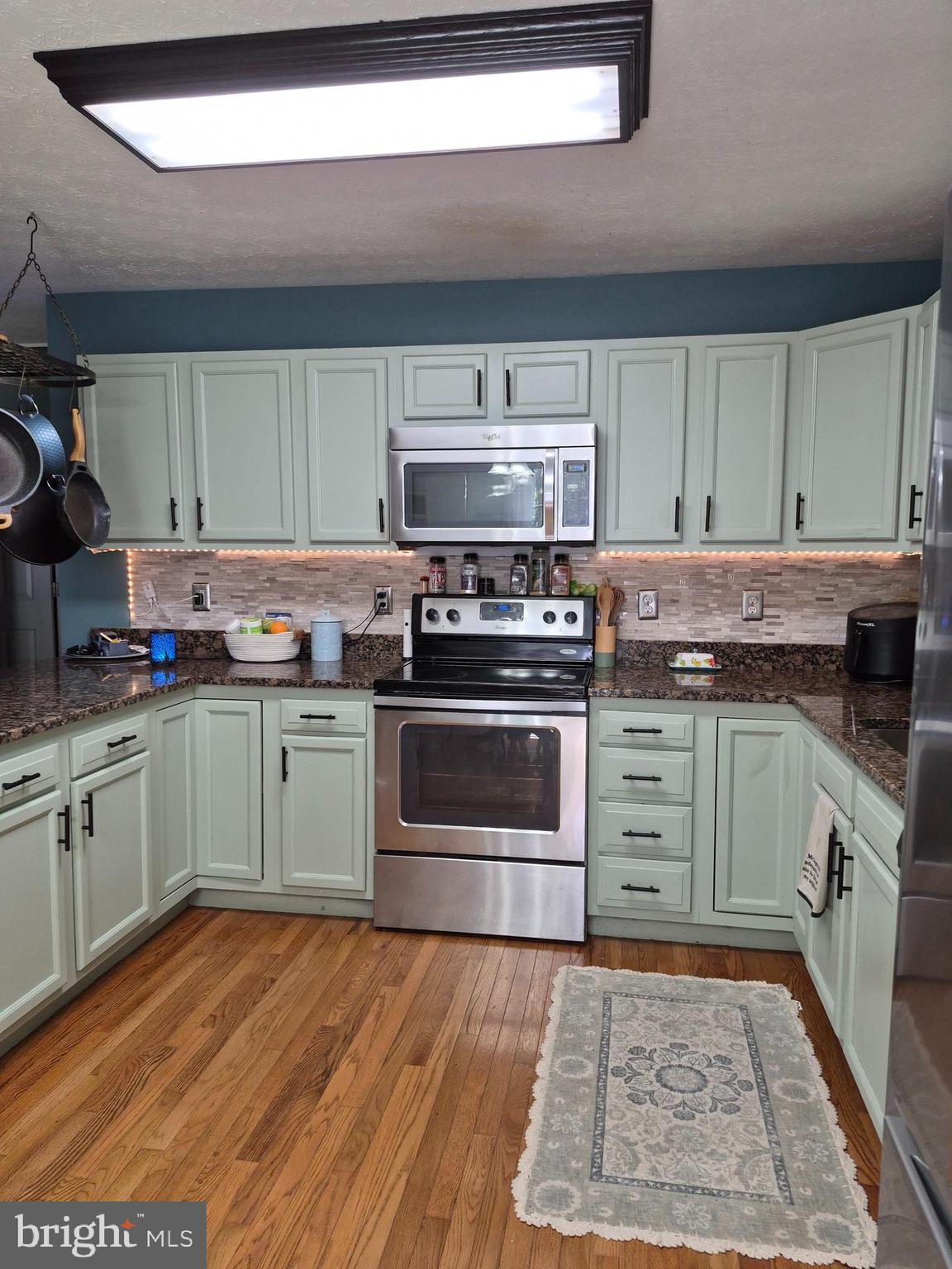 1440 Drummer Hill Road Front Royal, VA 22630 - Photo 18 of 42 a kitchen with granite countertop a stove top oven sink and cabinets