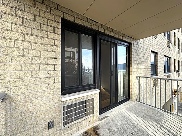 a living room with fireplace furniture and a large window