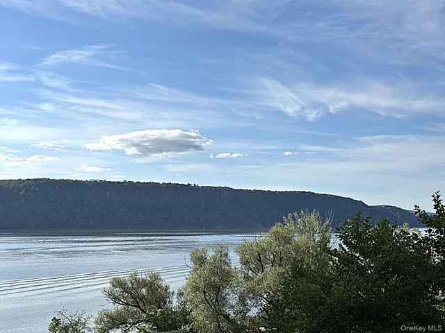 a living room with furniture a flat screen tv and a table