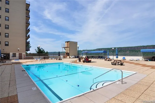 a view of swimming pool with outdoor seating and a potted plants
