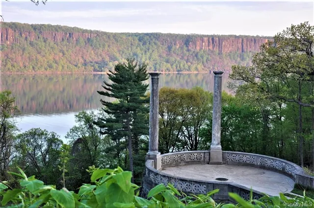 a view of a balcony with wooden floor and outdoor seating