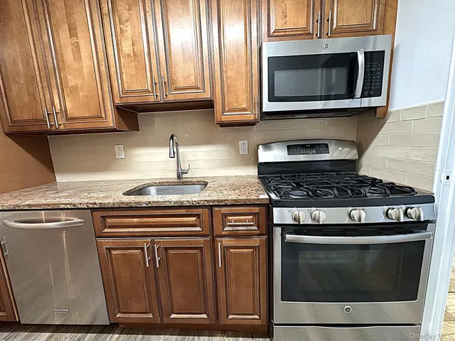 a stove top oven sitting inside of a kitchen