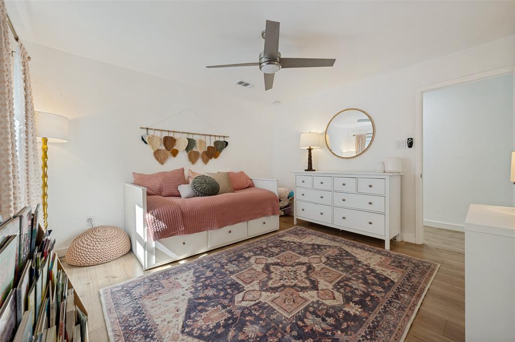 3619 Merrell Road Dallas, TX 75229 - Photo 14 of 26 Bright interior space featuring light wood-finish flooring, a contemporary ceiling fan, and white walls