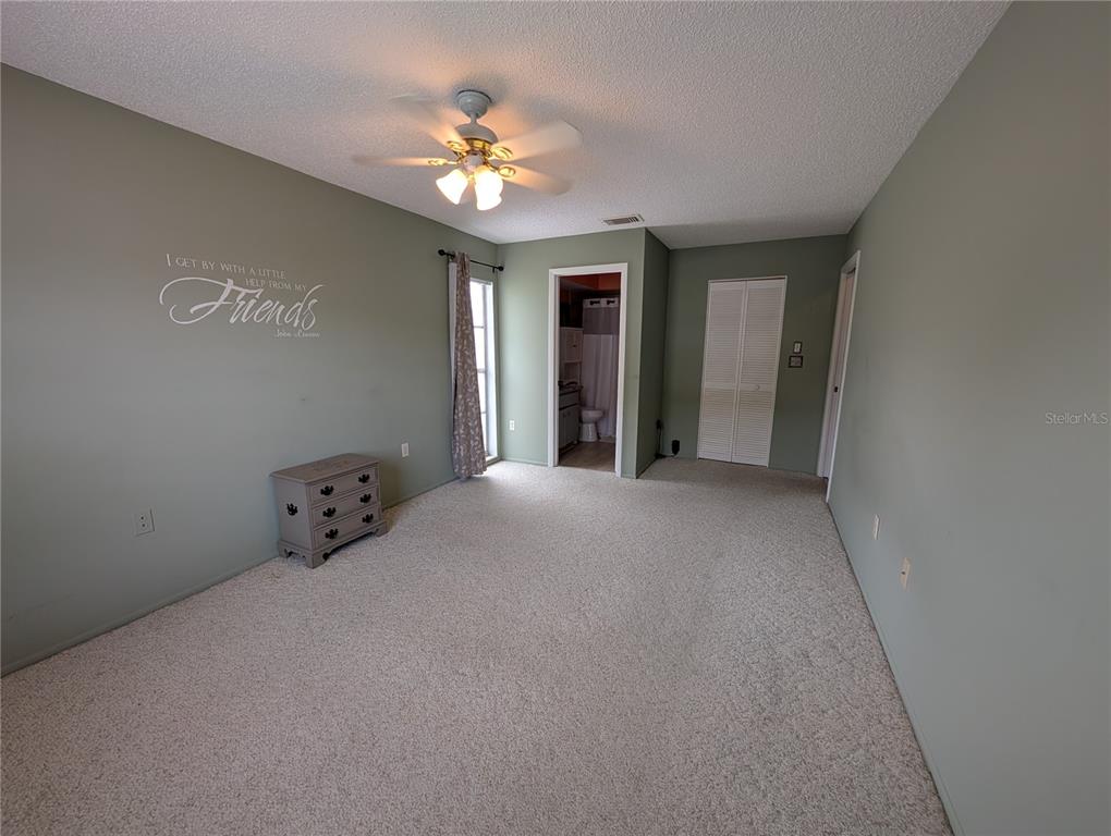 8161 Braddock Circle, Unit 1 Port Richey, FL 34668 - Photo 16 of 27 a view of a bedroom with chandelier and windows