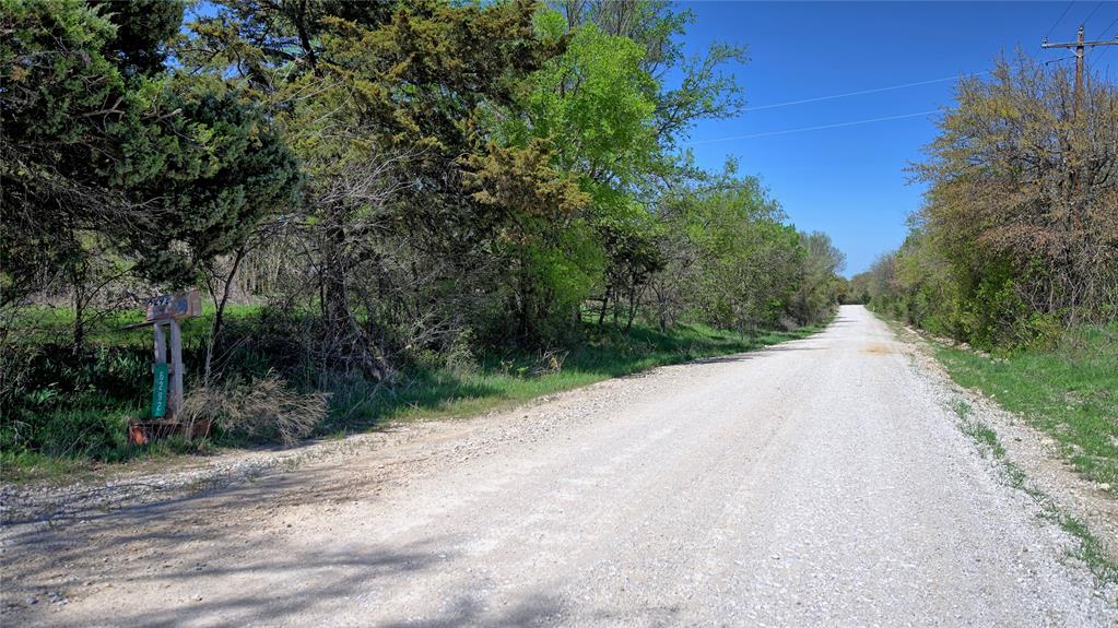 Tbd Well Service Road Bowie, TX 76230 - Photo 9 of 14 a view of a road with a trees in the background