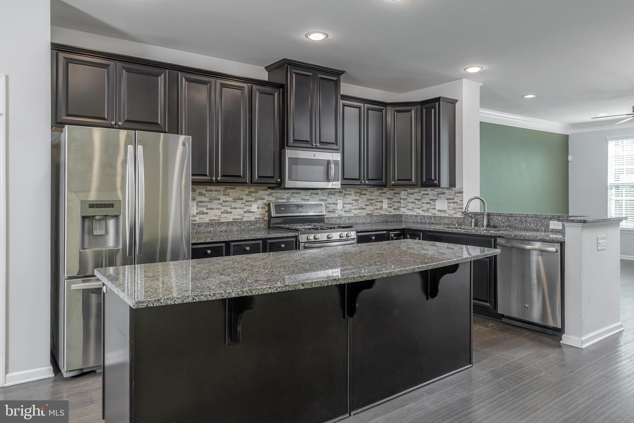 1036 Regency Place Sewell, NJ 08080 - Photo 8 of 18 a kitchen with stainless steel appliances granite countertop a sink stove and refrigerator