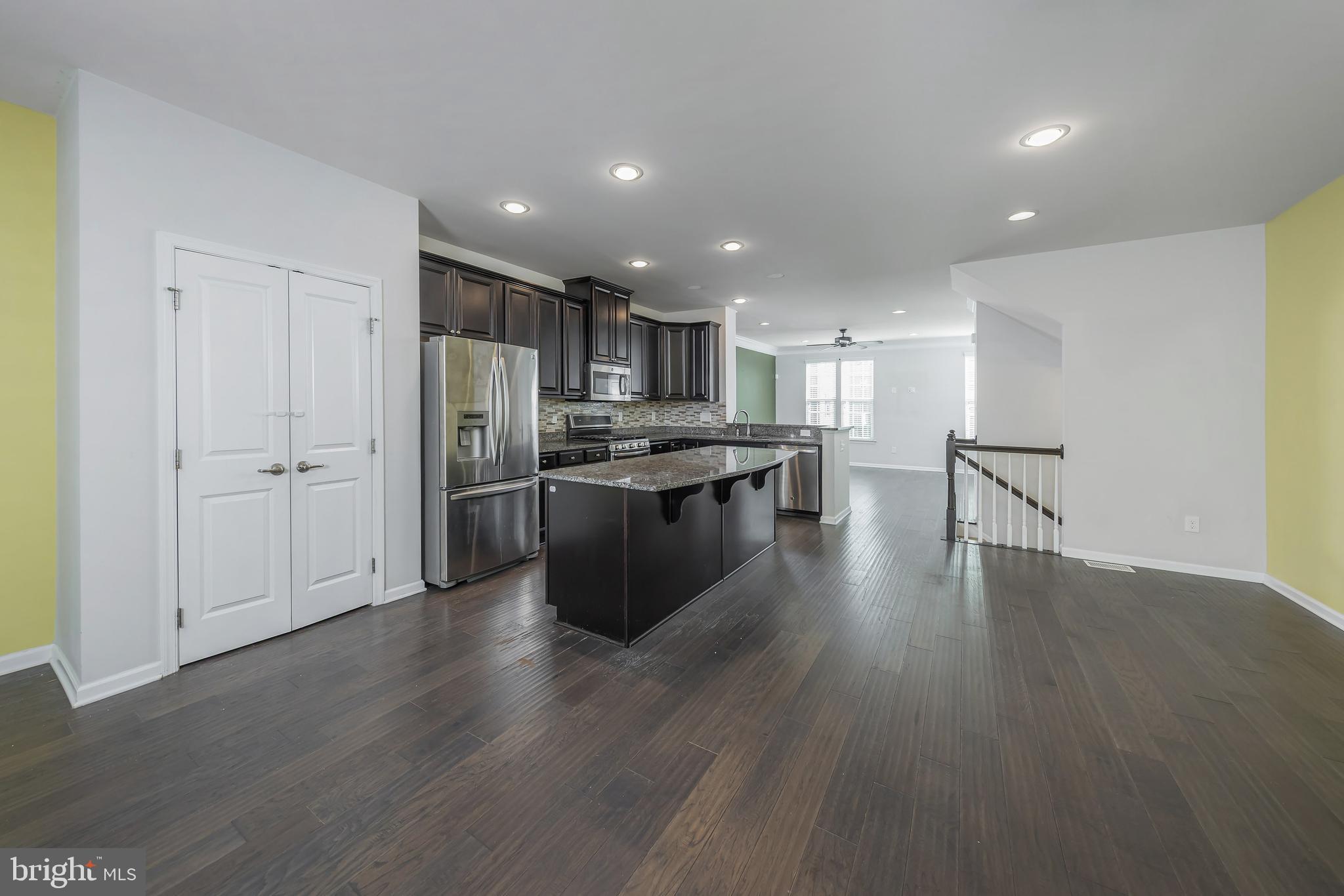 1036 Regency Place Sewell, NJ 08080 - Photo 9 of 18 a kitchen with stainless steel appliances granite countertop a stove top oven a refrigerator a sink and a oven with wooden floor
