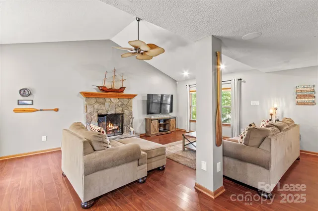 a living room with furniture a fireplace and a chandelier