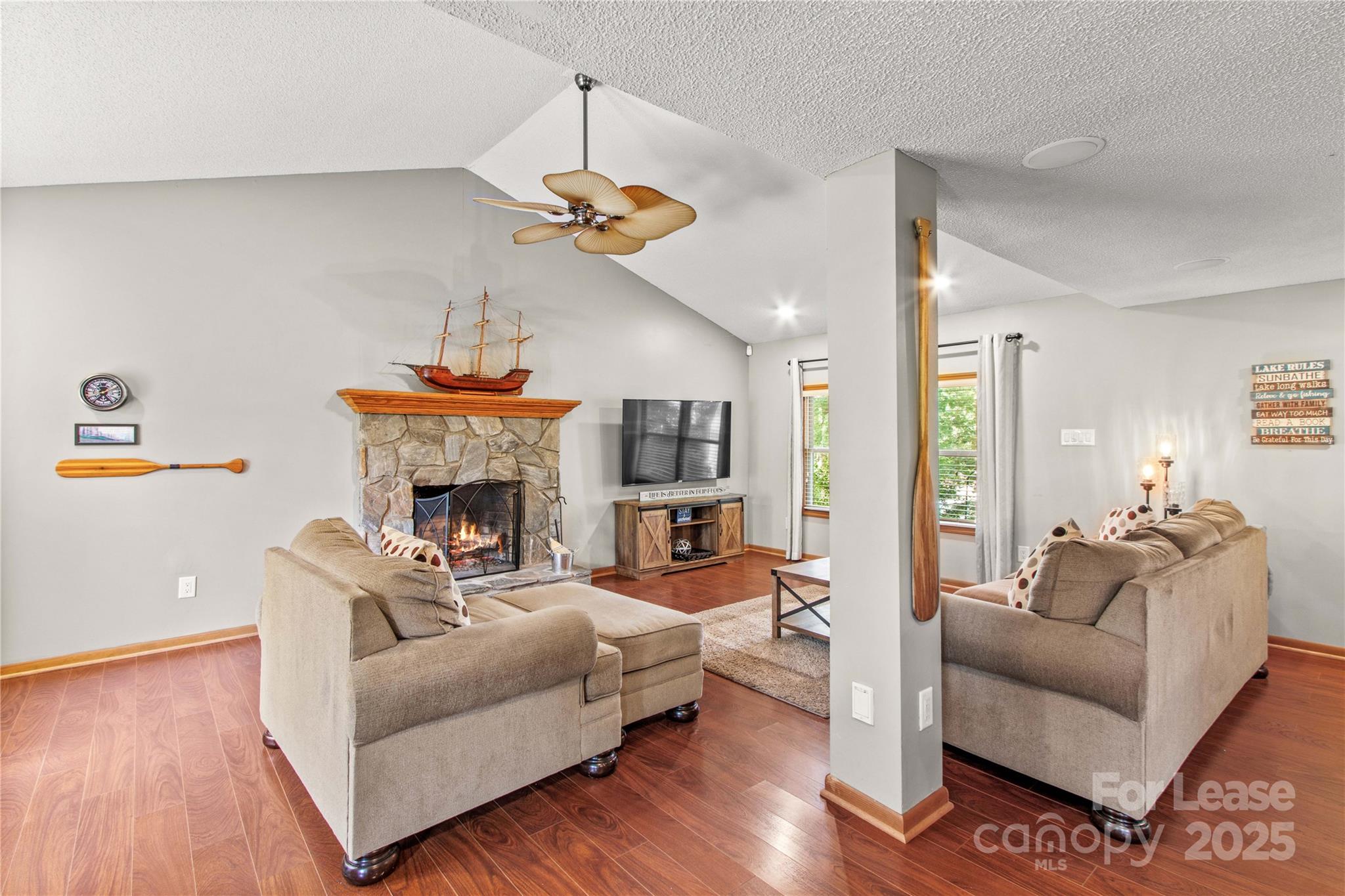 173 Waddell Road Mooresville, NC 28117 - Photo 11 of 47 a living room with furniture a fireplace and a chandelier