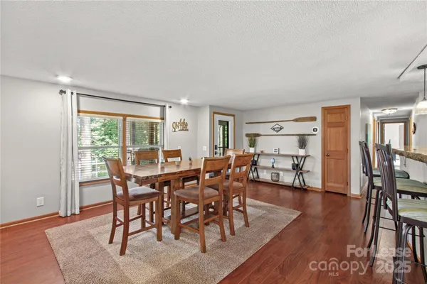 a view of a dining room with furniture and wooden floor