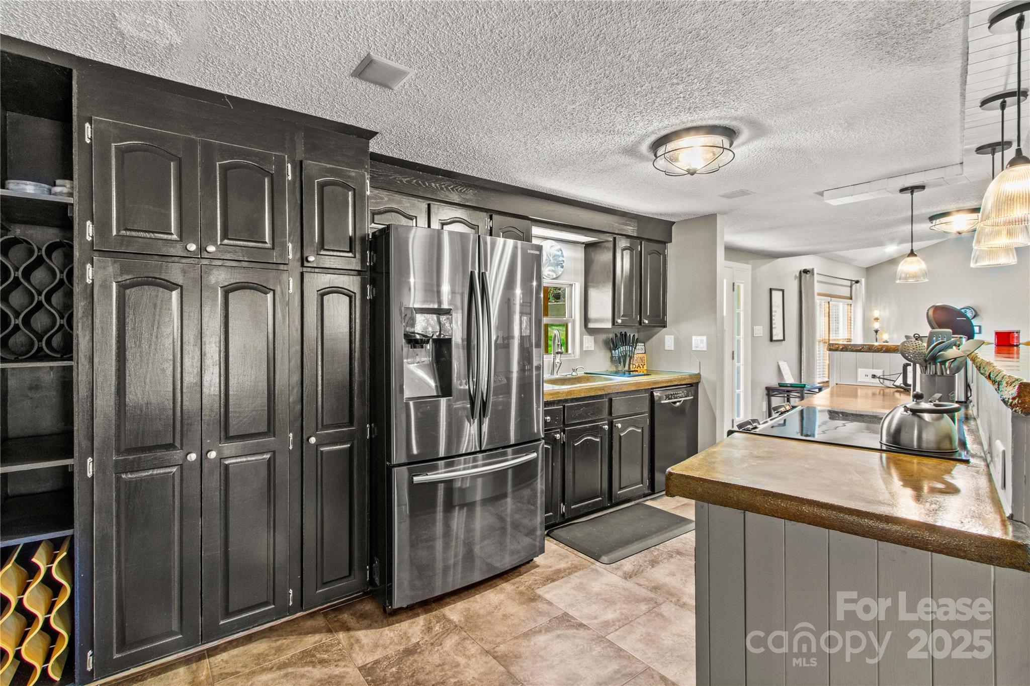 173 Waddell Road Mooresville, NC 28117 - Photo 17 of 47 a kitchen with granite countertop a refrigerator and stainless steel appliances