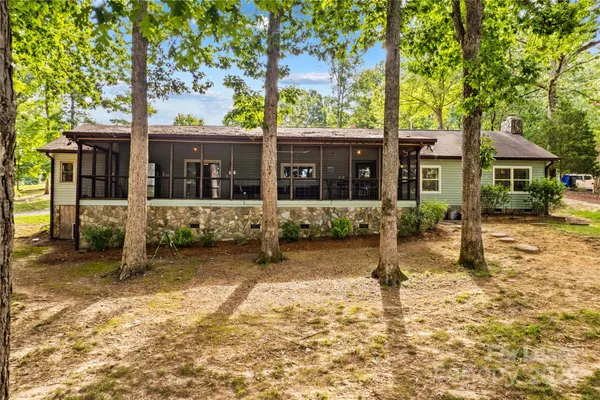 front view of a house with a large tree