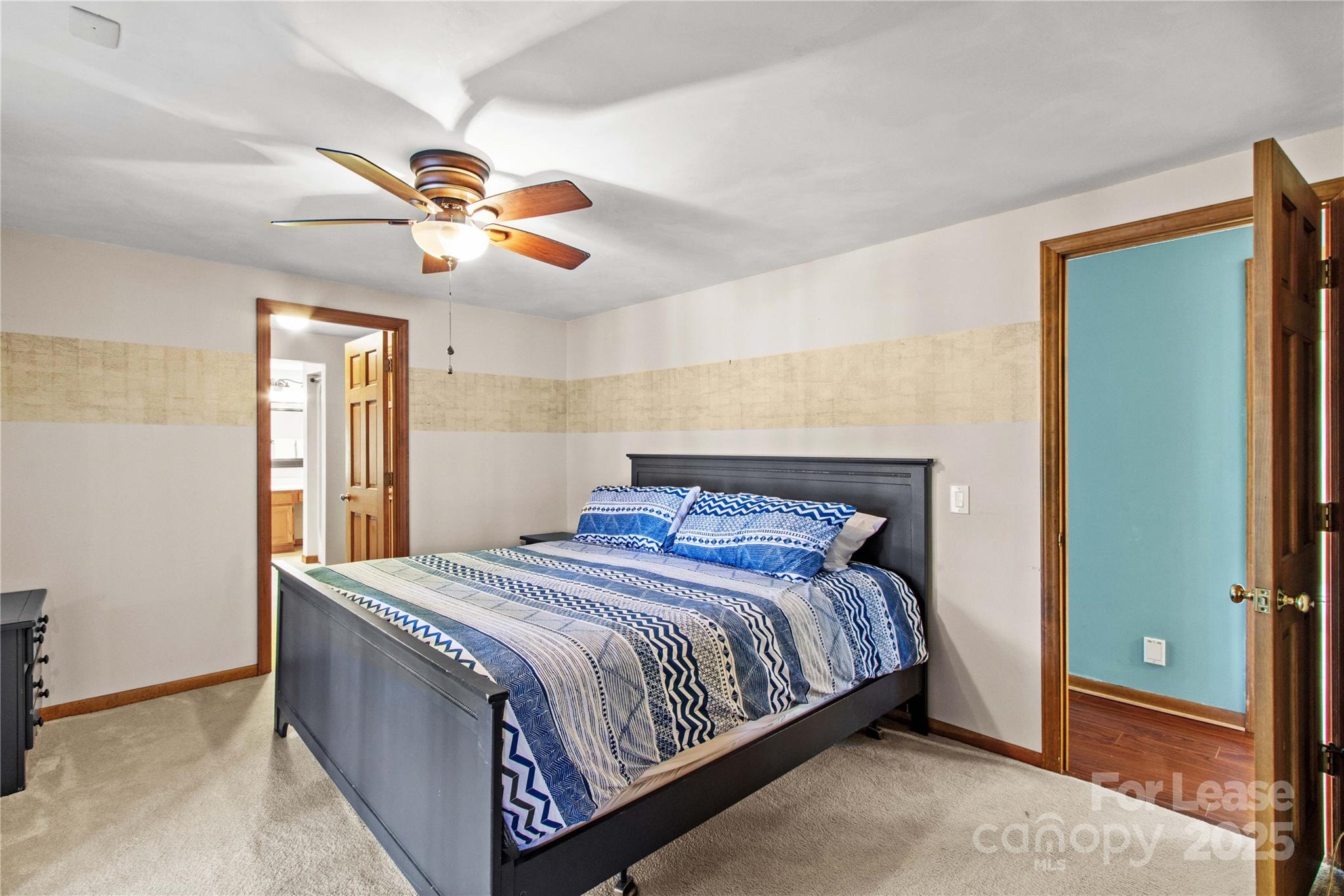 173 Waddell Road Mooresville, NC 28117 - Photo 21 of 47 a bedroom with a bed and a chandelier