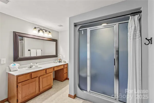 a bathroom with a granite countertop sink mirror and double