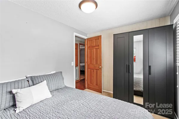 a bedroom with a bed and a mirror
