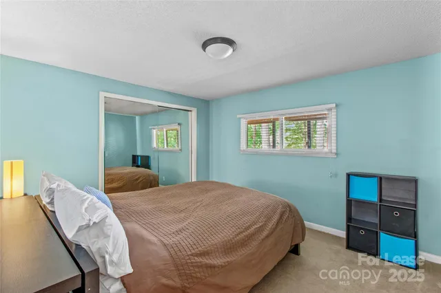a bedroom with a bed and a bookshelf